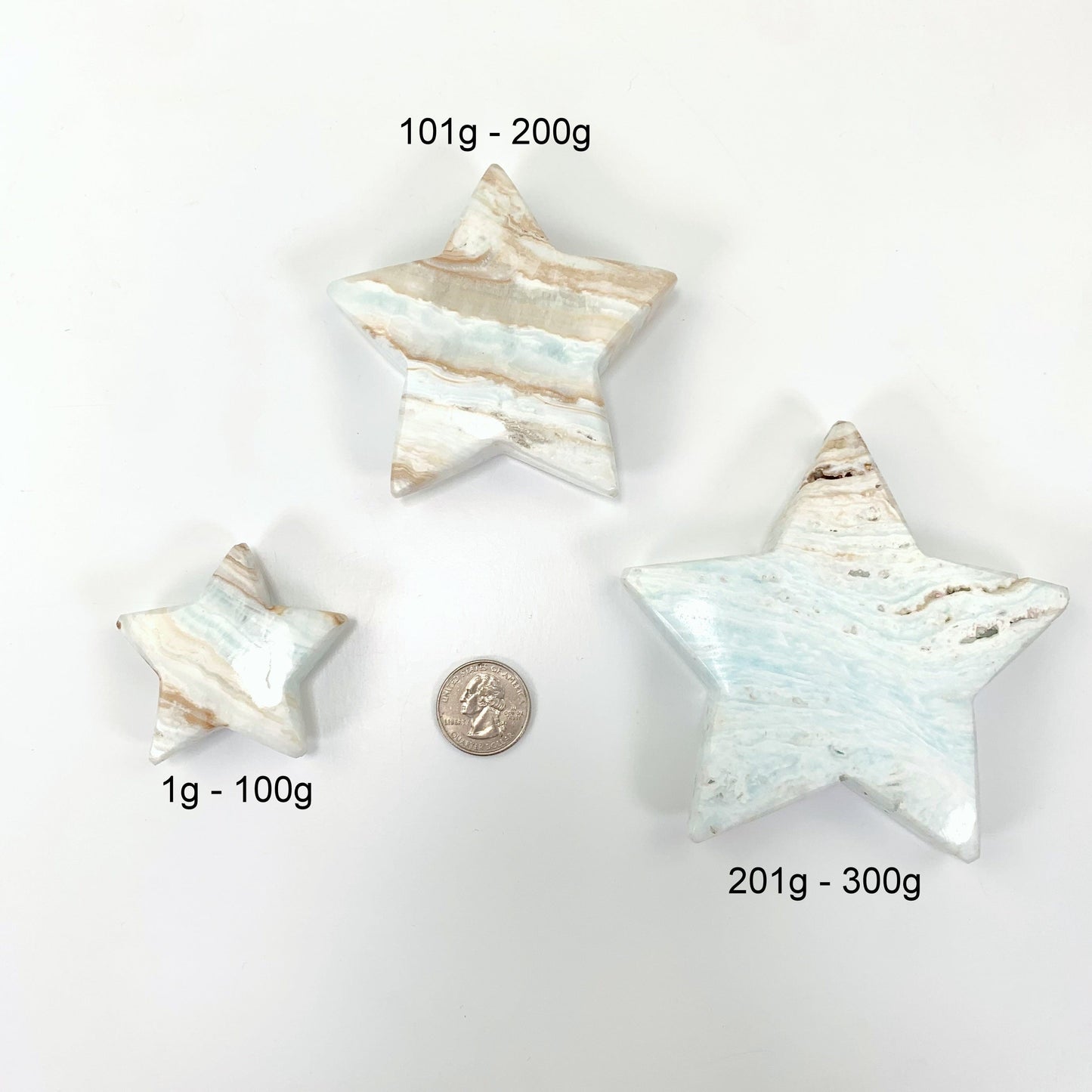 all three stars laid out on a white background with a quarter