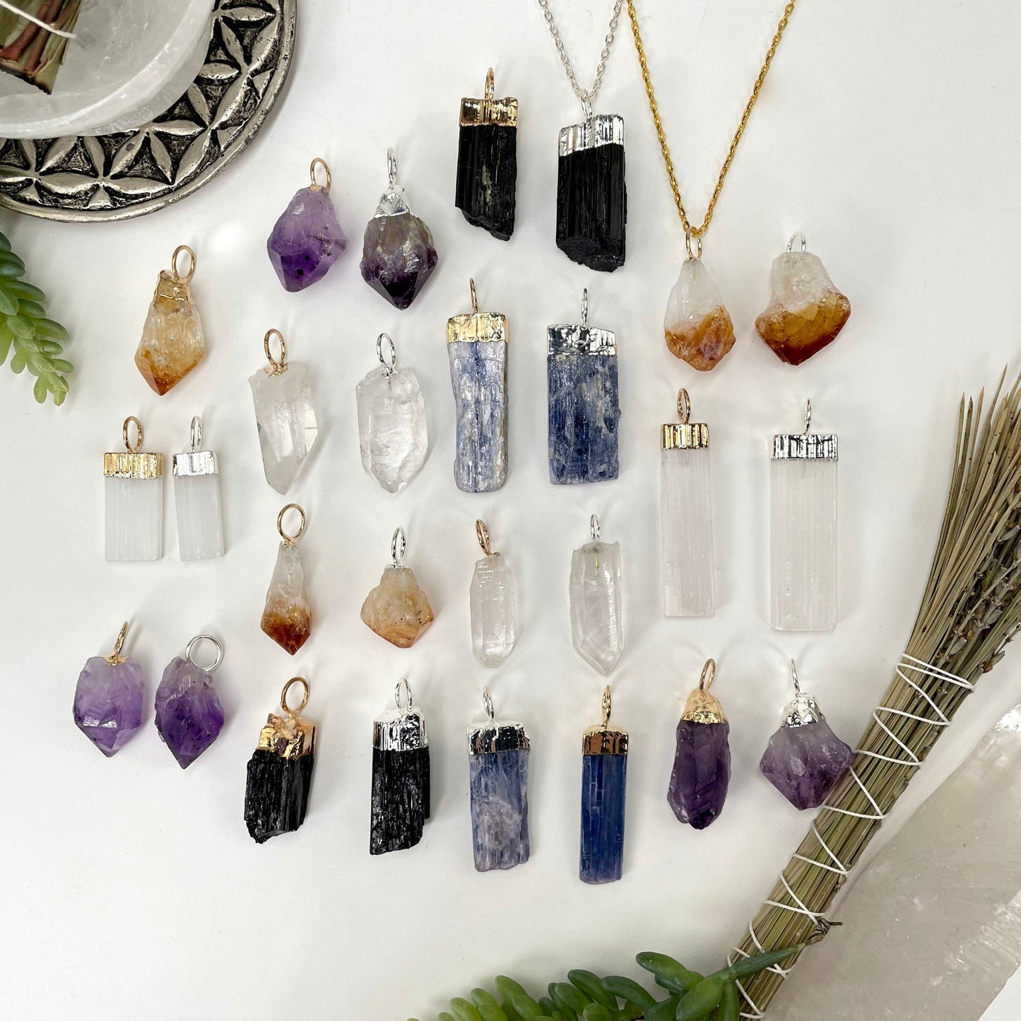 many different gemstone point pendants on display