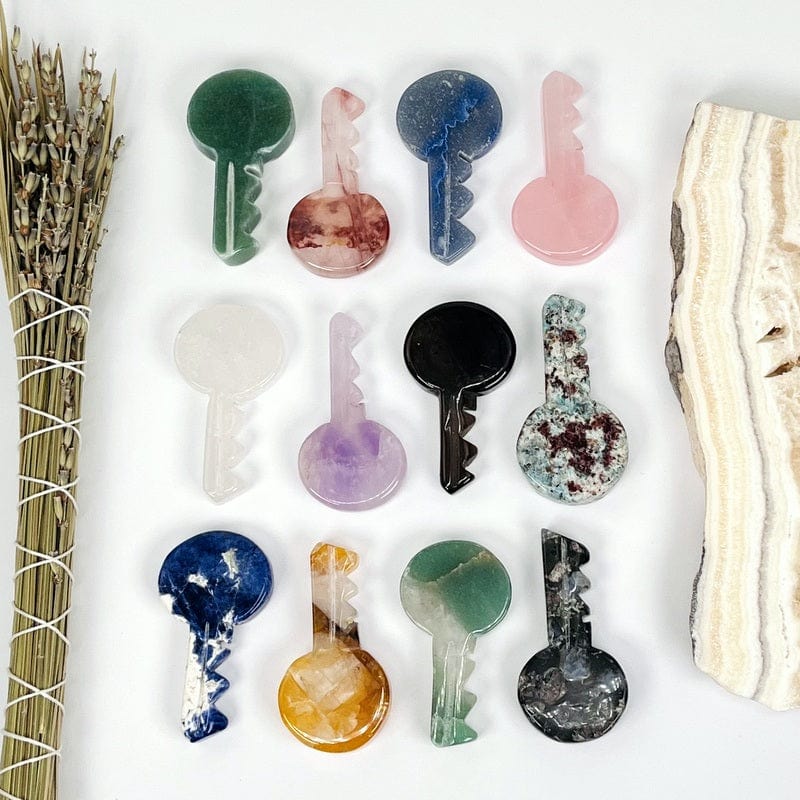 multiple gemstone keys lined up next to each other to show the differences in the stones 