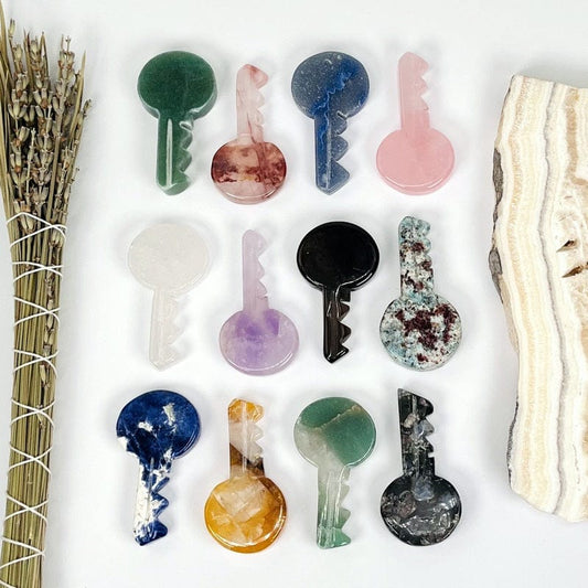 multiple gemstone keys lined up next to each other to show the differences in the stones 