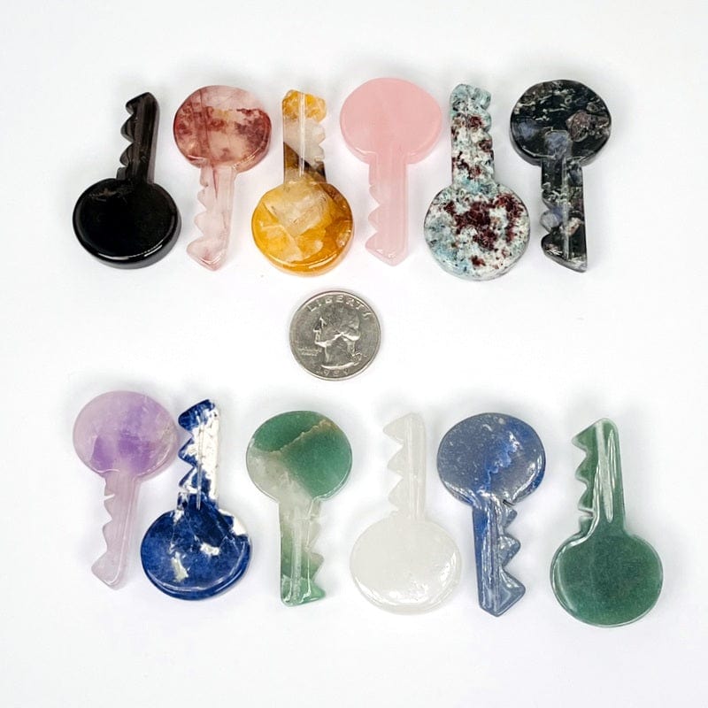 gemstone keys next to a quarter for size reference 