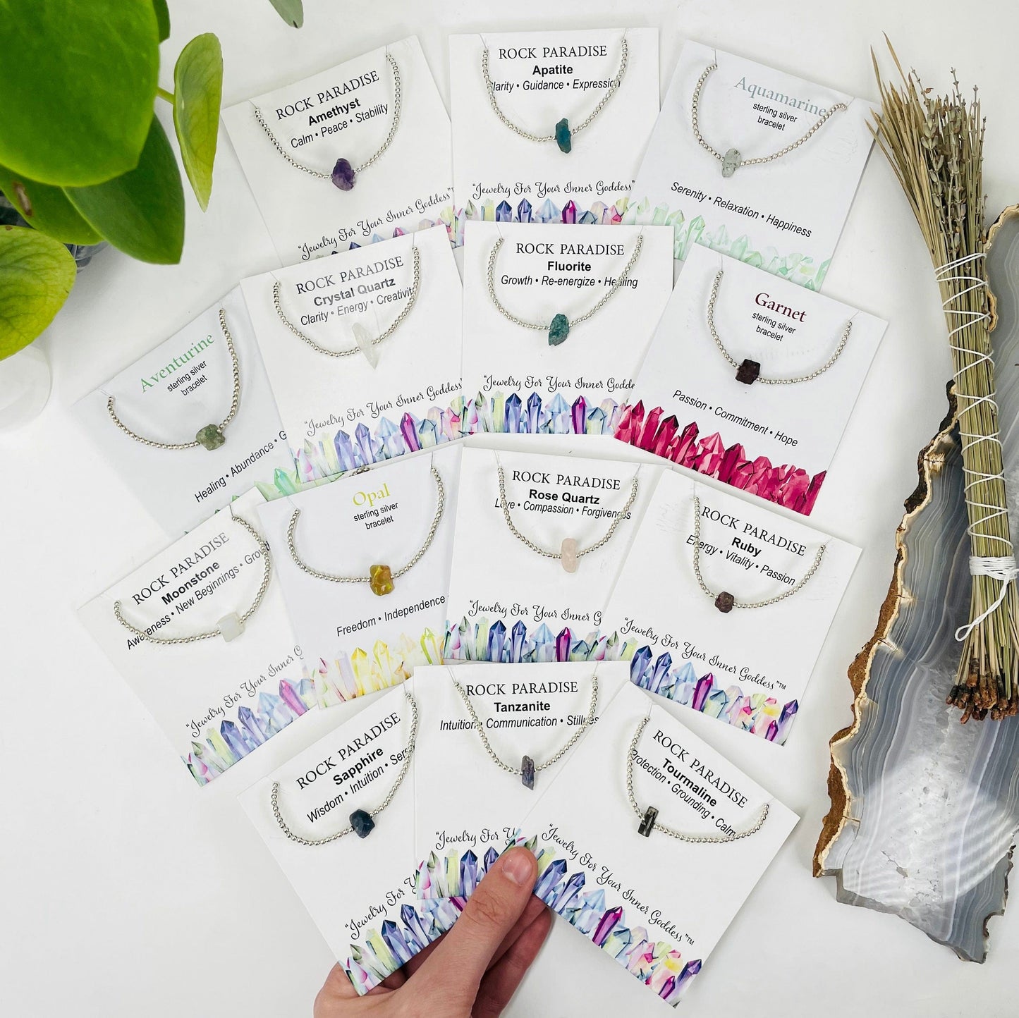 overhead view of all silver rough stone bracelets in their labeled packages 