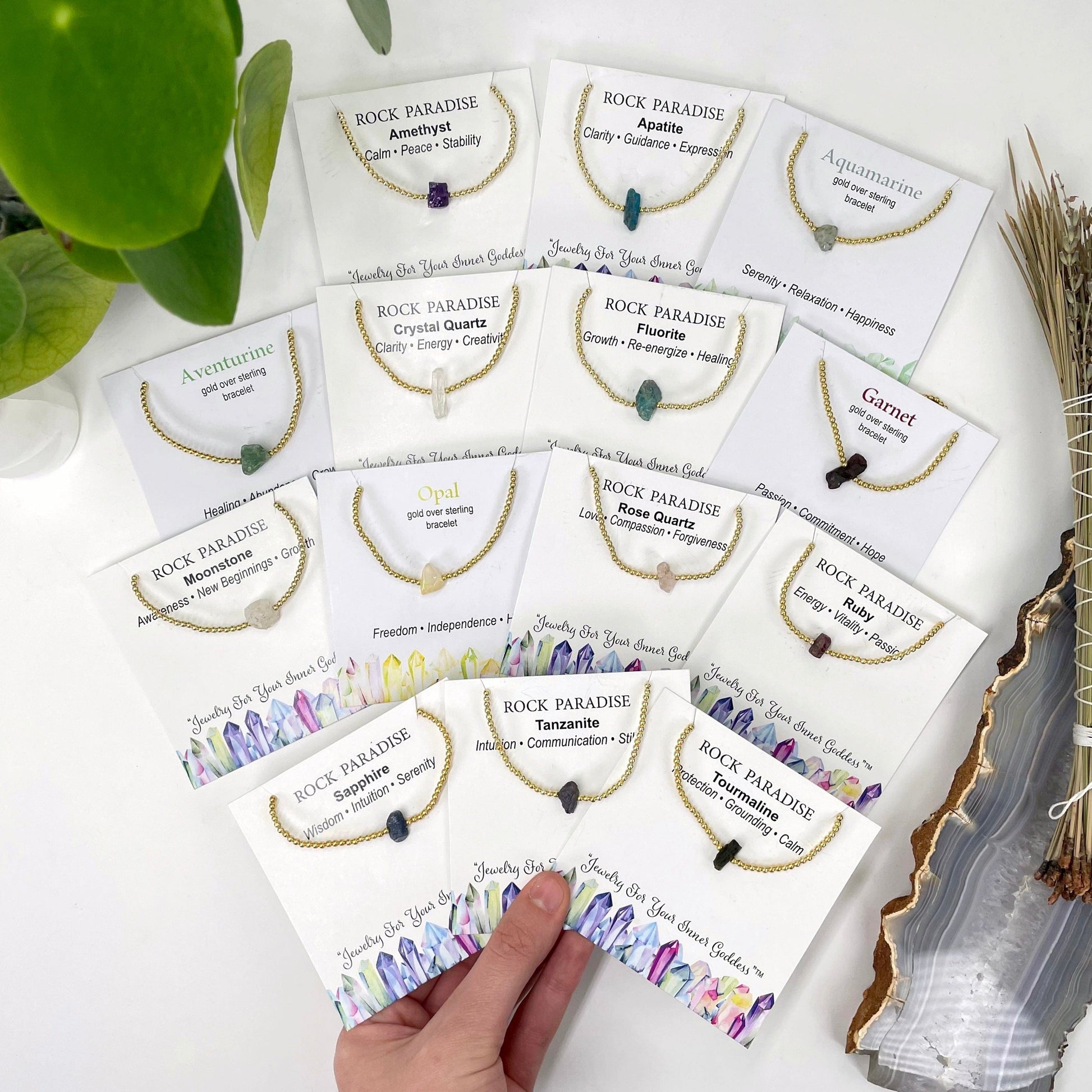 overhead view of all gold rough stone bracelets in their labeled packages 
