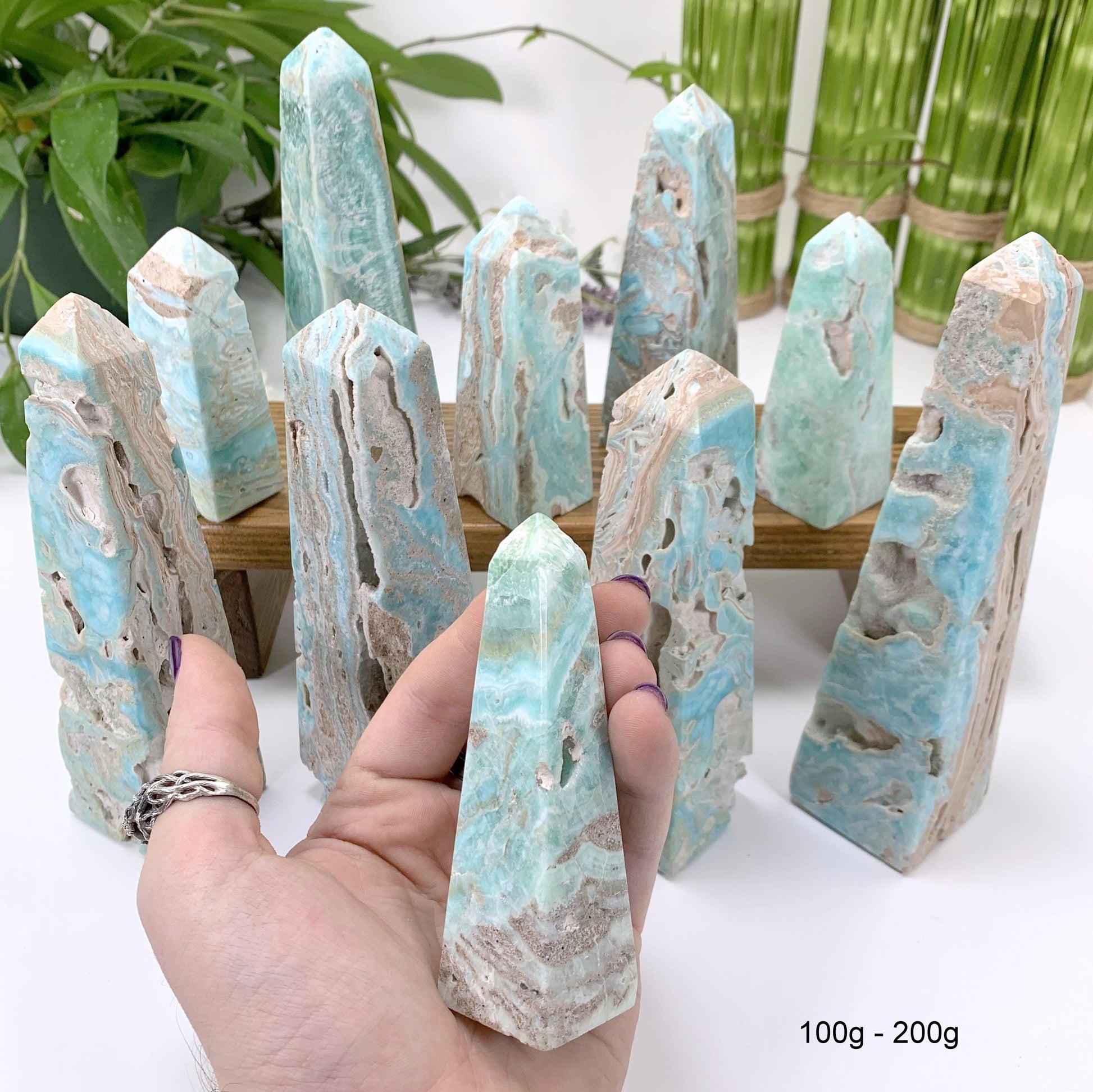 100 gram - 200 gram obelisk in hand with white background