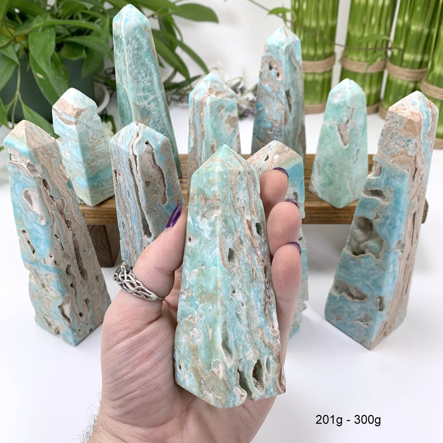 201 gram - 300 gram obelisk in hand with white background