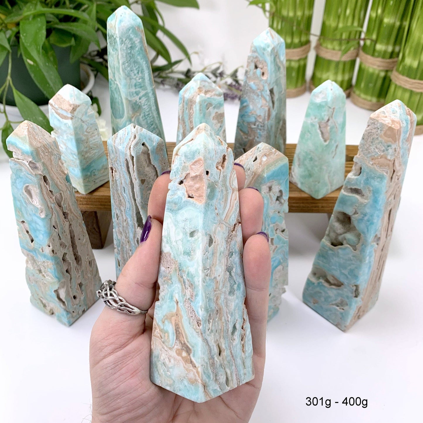 301 gram - 400 gram obelisk in hand with white background