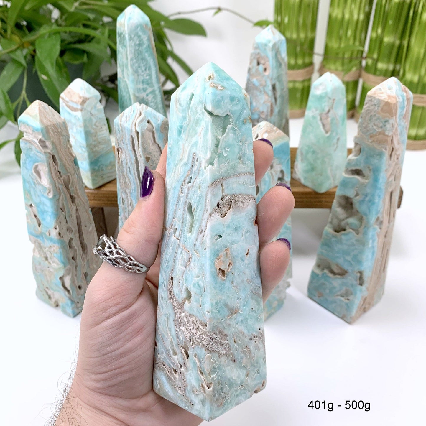 401 gram - 500 gram obelisk in hand with white background