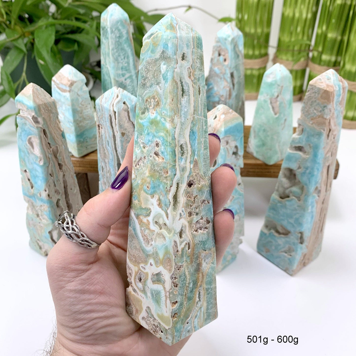 501 gram - 600 gram obelisk in hand with white background