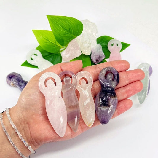 carved gemstone goddesses in hand for size reference 