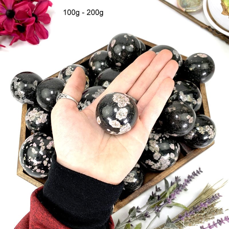 black jade sphere in a hand
