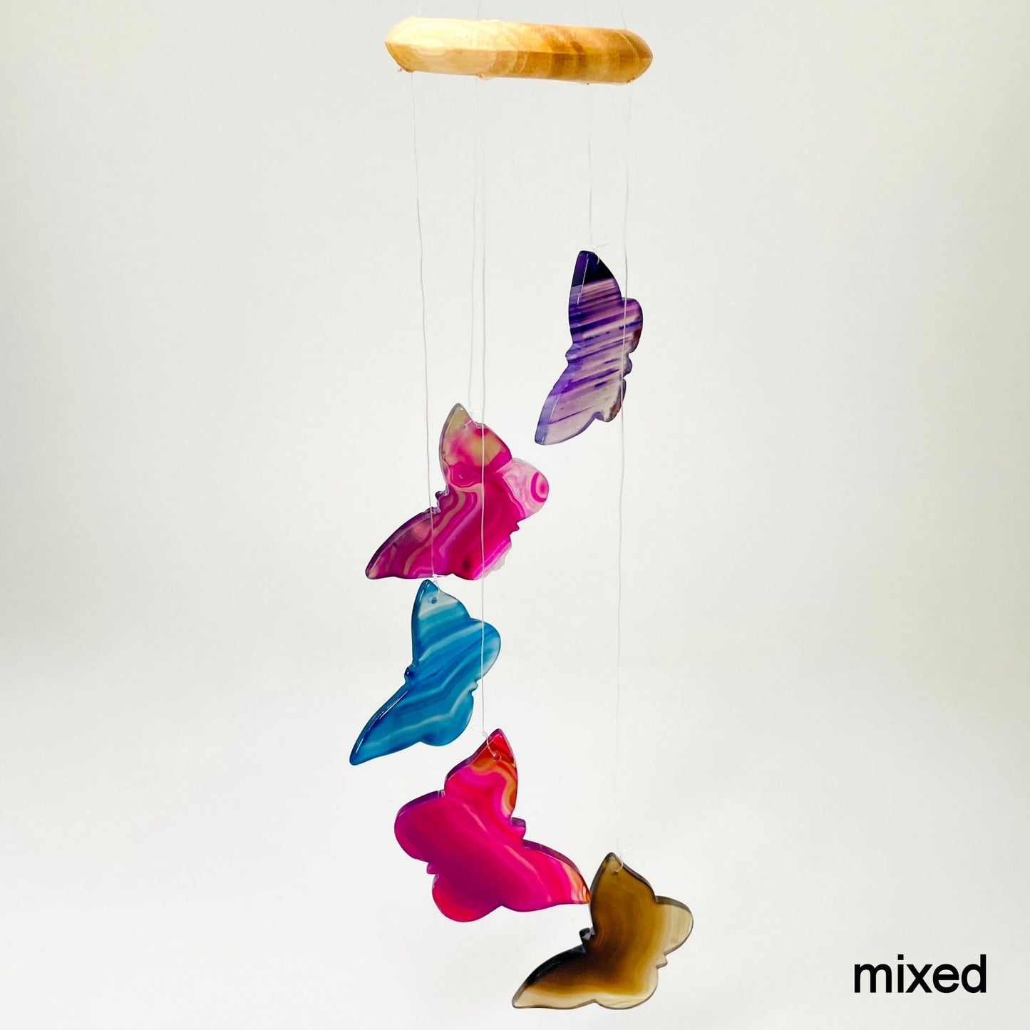 one mixed agate butterfly wind chime hanging in front of white background