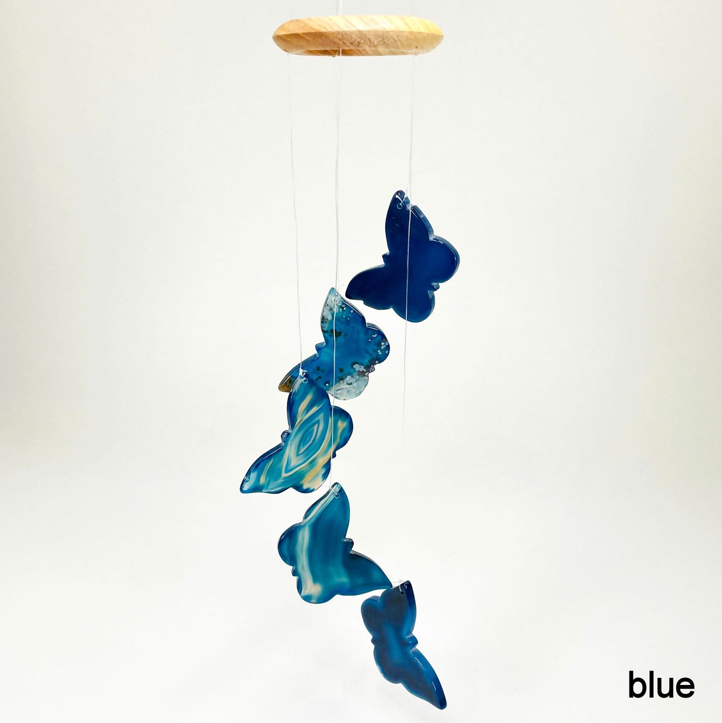 one blue agate butterfly wind chime hanging in front of white background