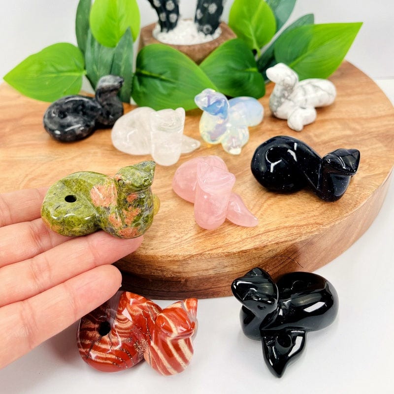 multiple gemstone snakes displayed to show the differences in the stone types 