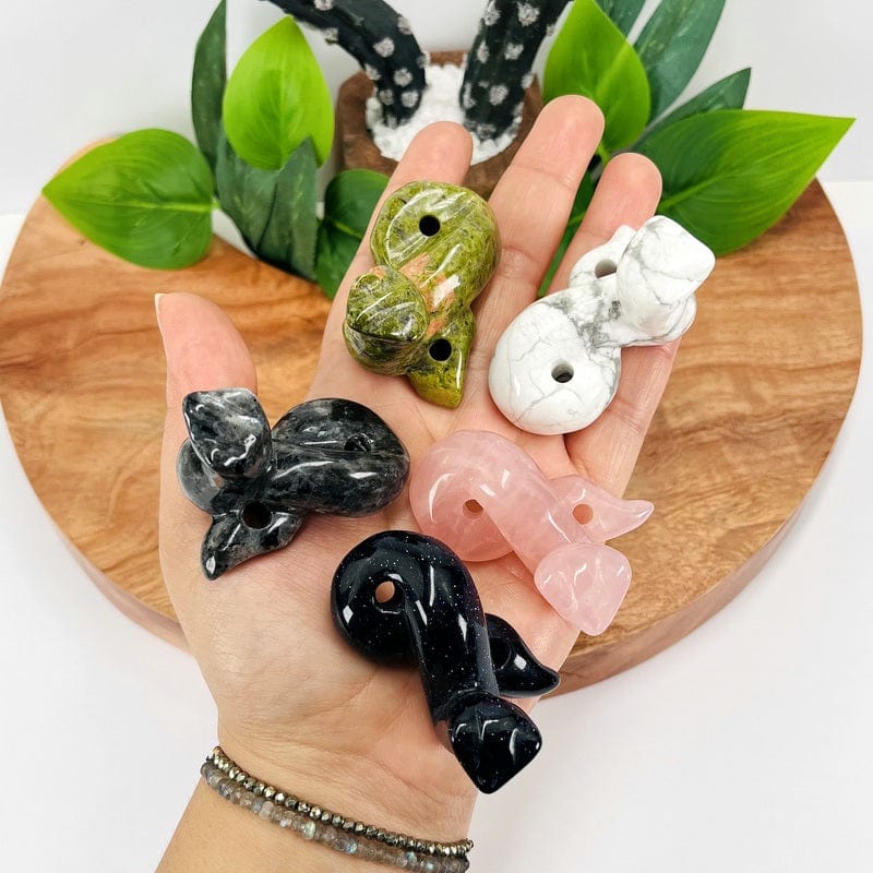 gemstone snakes on hand for size reference 