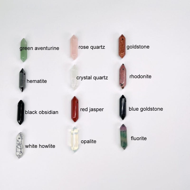 crystal double terminated pencil points next to their stone name. available in green aventurine, hematite, black obsidian, white howlite, rose quartz, crystal quartz, red jasper, opalite, goldstone, rhodonite, blue goldstone, and fluorite. 