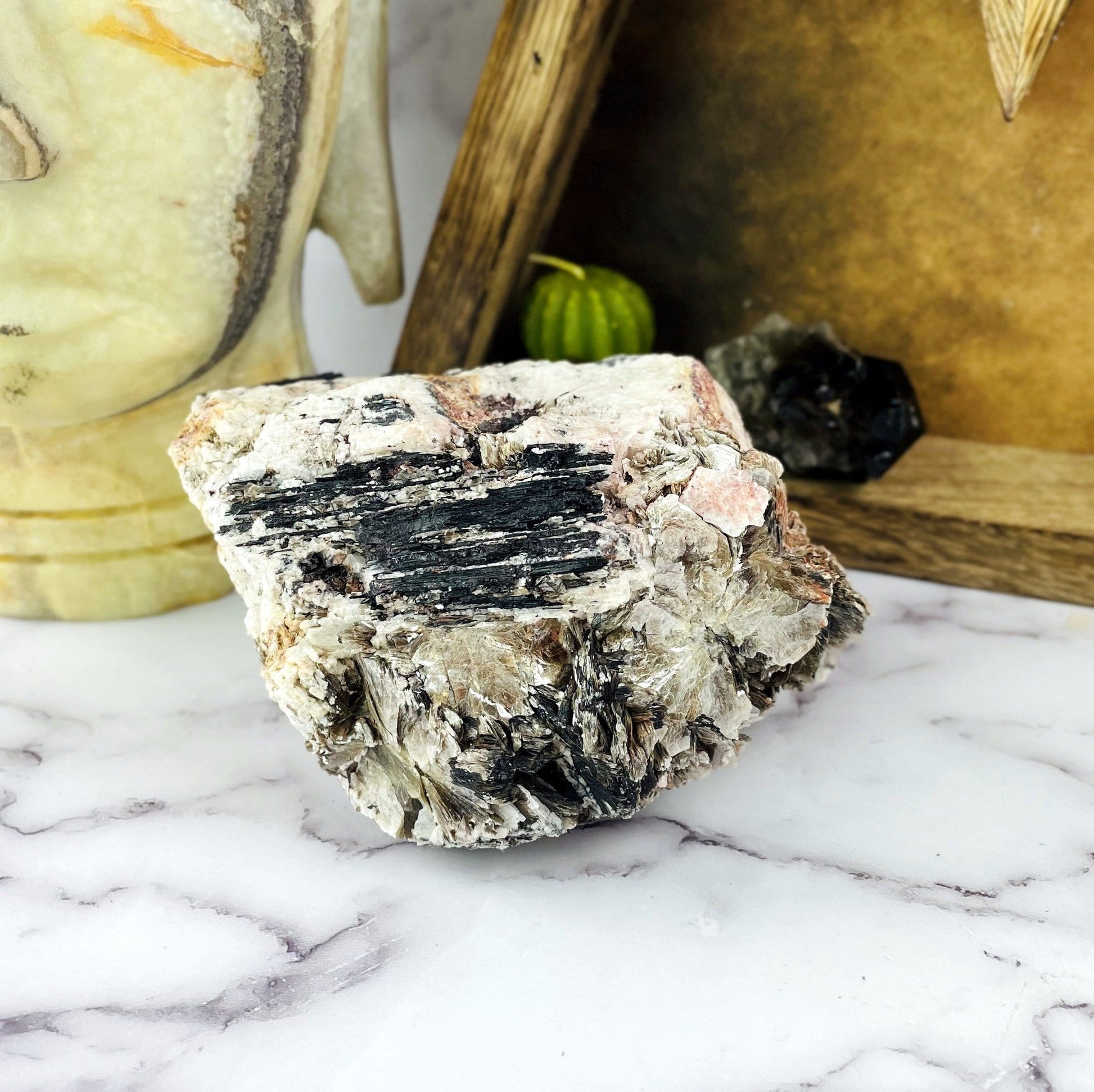 Black Tourmaline With Mica with decorations in the background