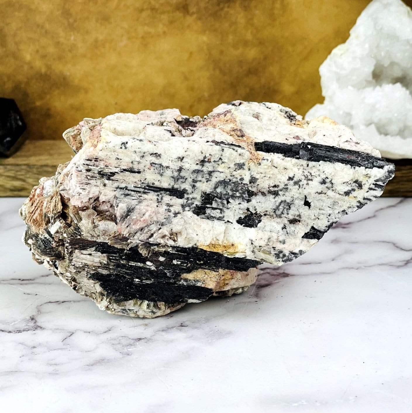 Black Tourmaline With Mica with decorations in the background