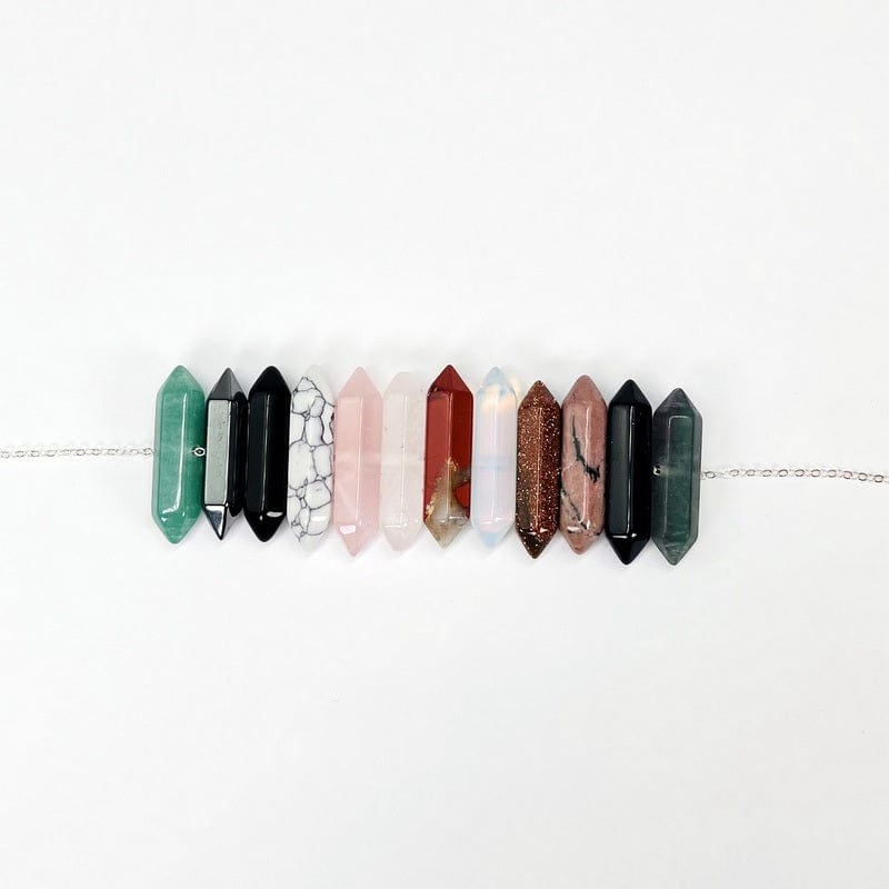 double terminated pencil point beads on a silver chain to show the drill hole 