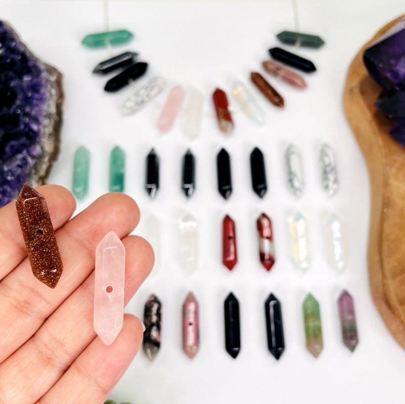 double terminated pencil point beads in hand for size reference 