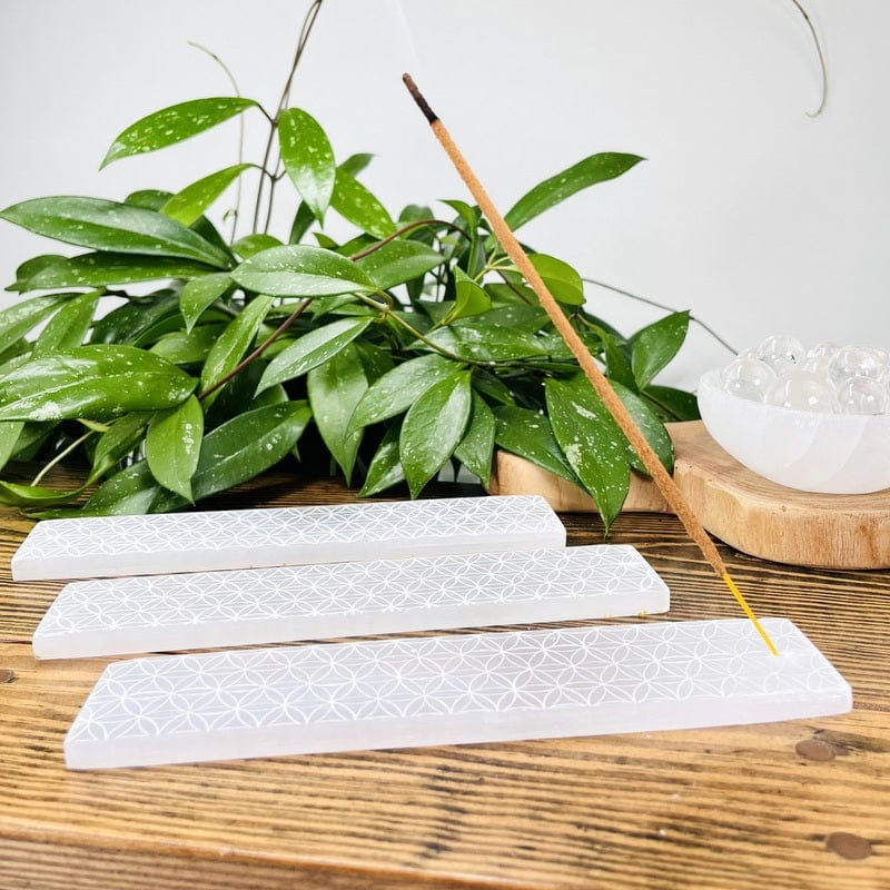 selenite burners with an incense stick inserted to show it in use 