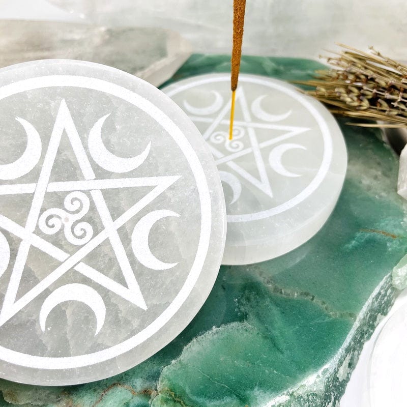close up of the details on the star, moons and the drilled hole for the incense stick