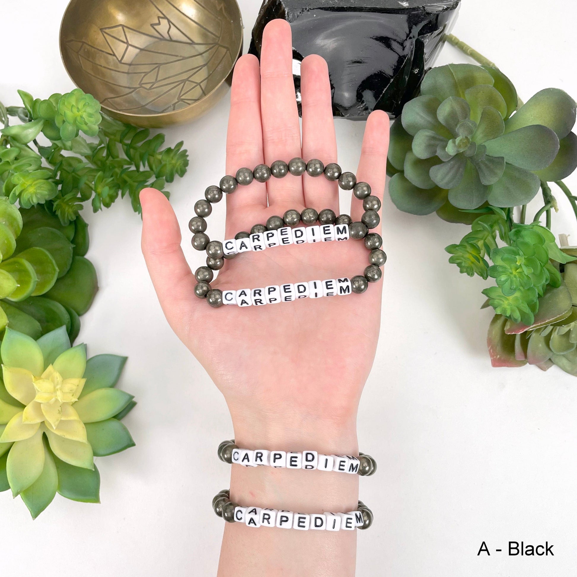 black "CARPEDIEM" letter bead option in hand and on wrist for color reference