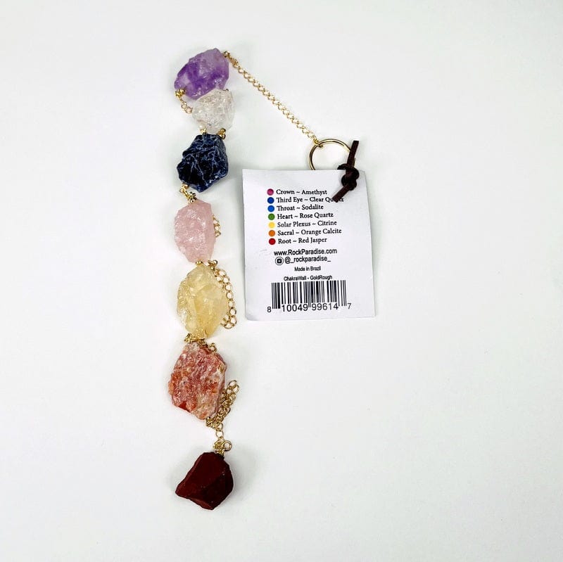 close up of rough stones and the tag that has chakra and stone information 