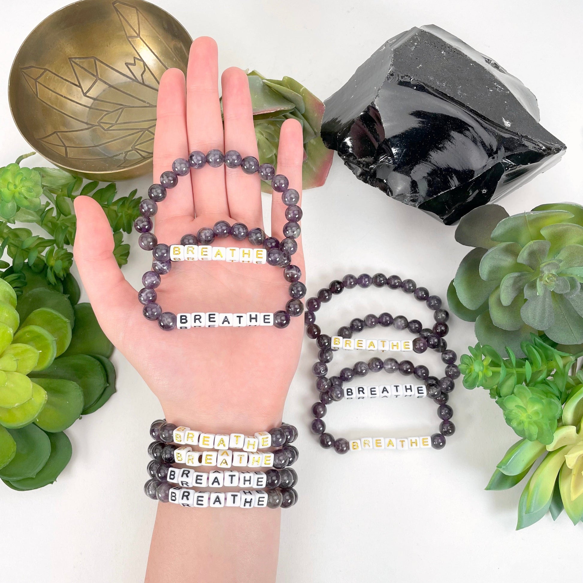 amethyst beaded bracelet in hand and on wrist with display