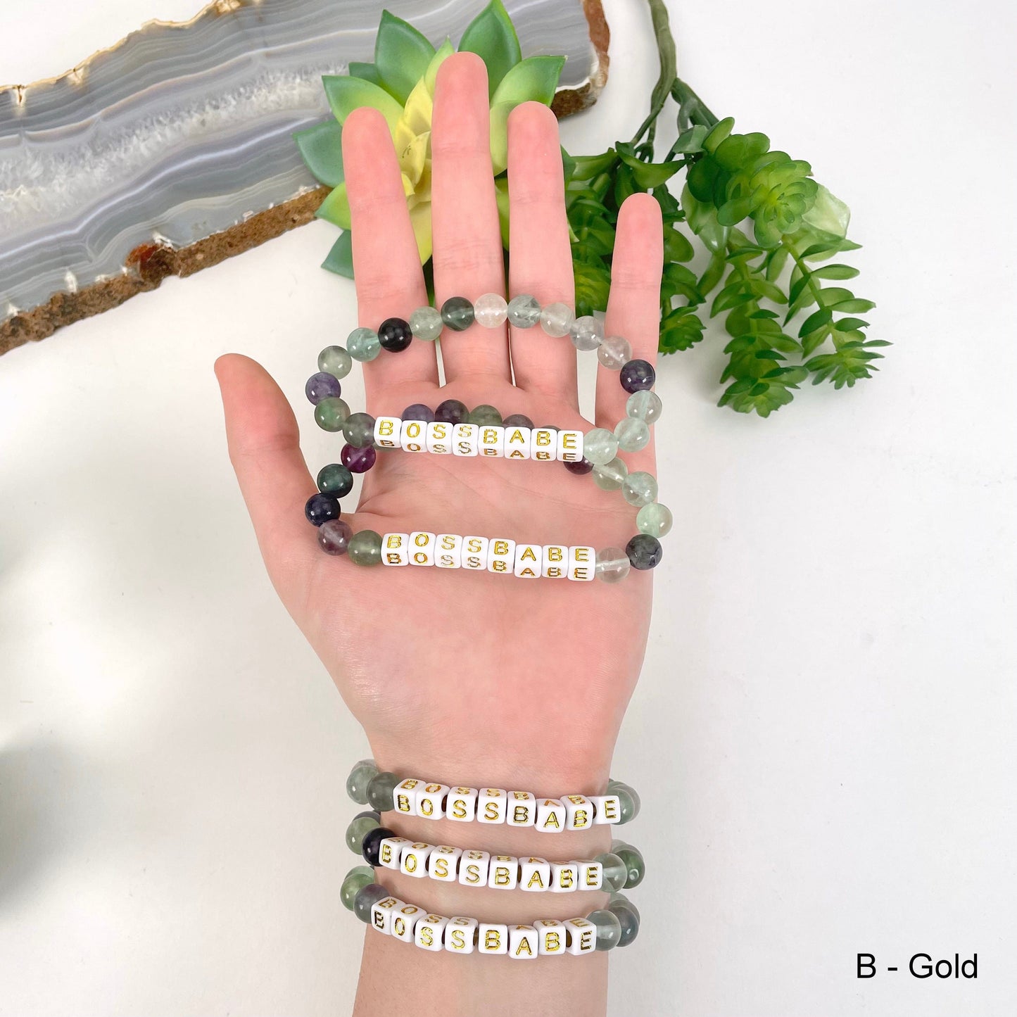 gold "BOSSBABE" letter bead option in hand and on wrist for color reference