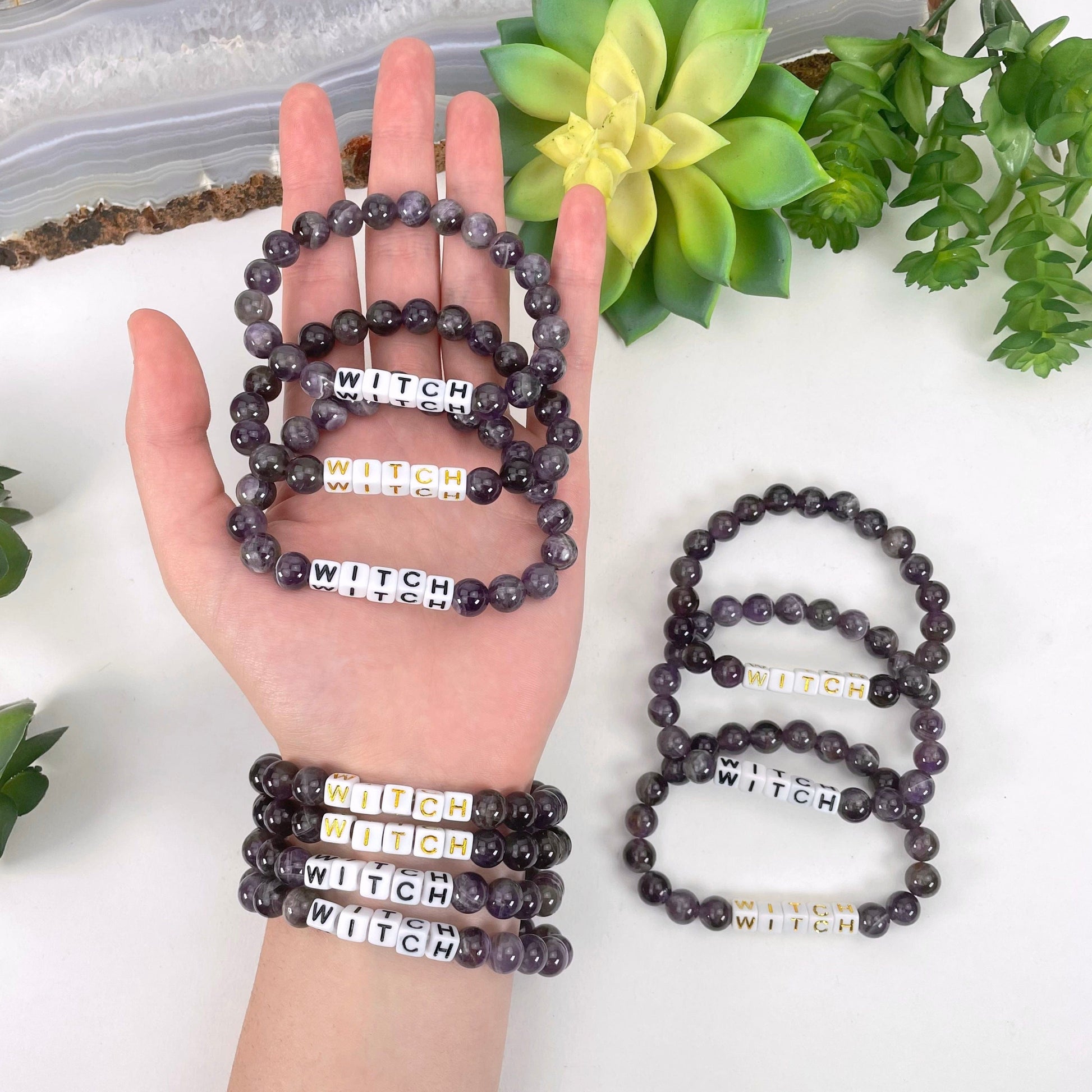 amethyst beaded bracelets in hand and on wrist with display