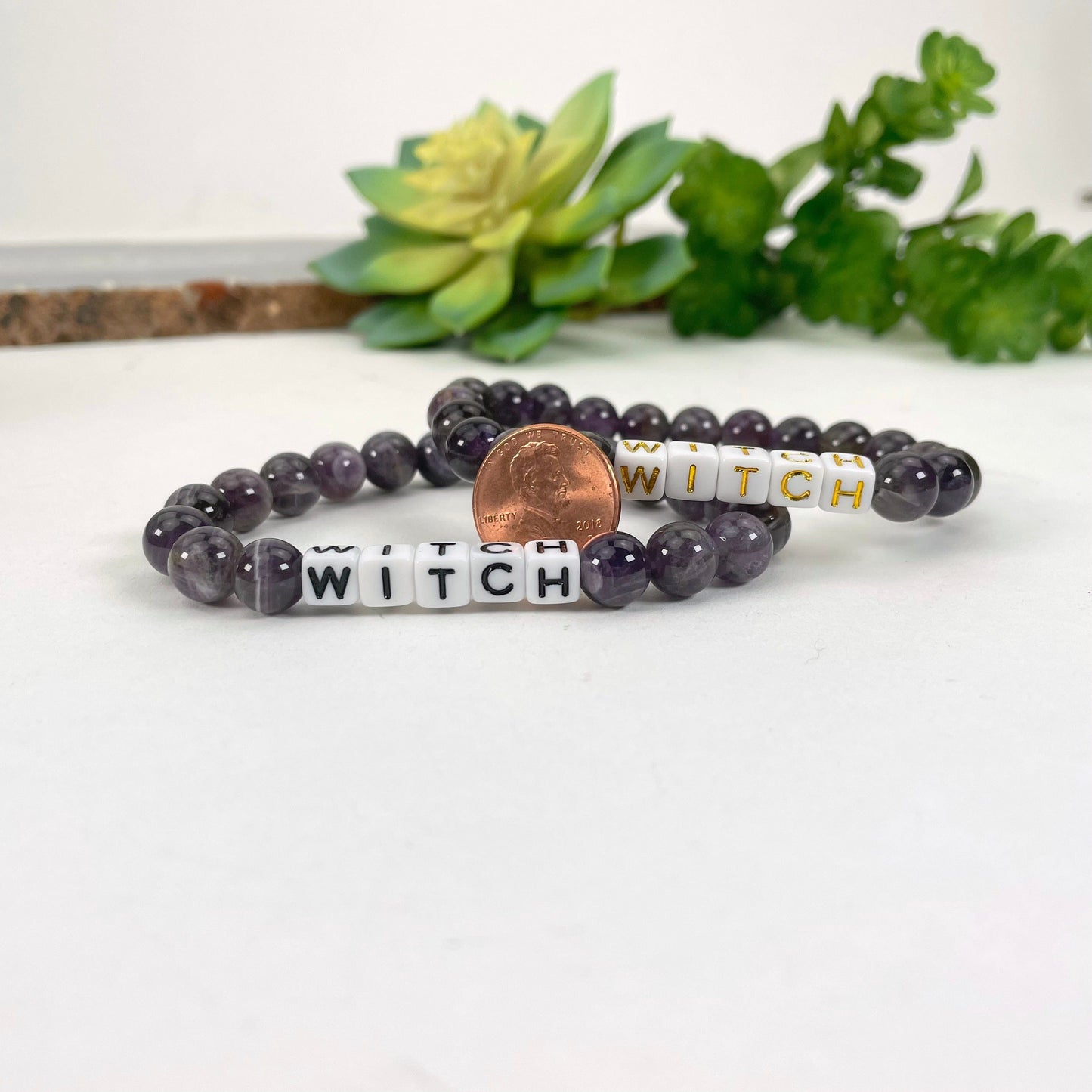 close up of amethyst beaded bracelets with penny for size reference