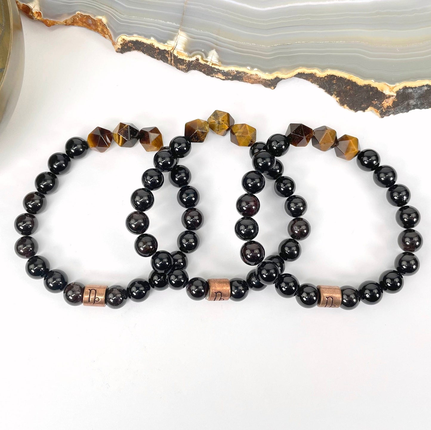 close up of capricorn zodiac bracelets for details and possible variations 