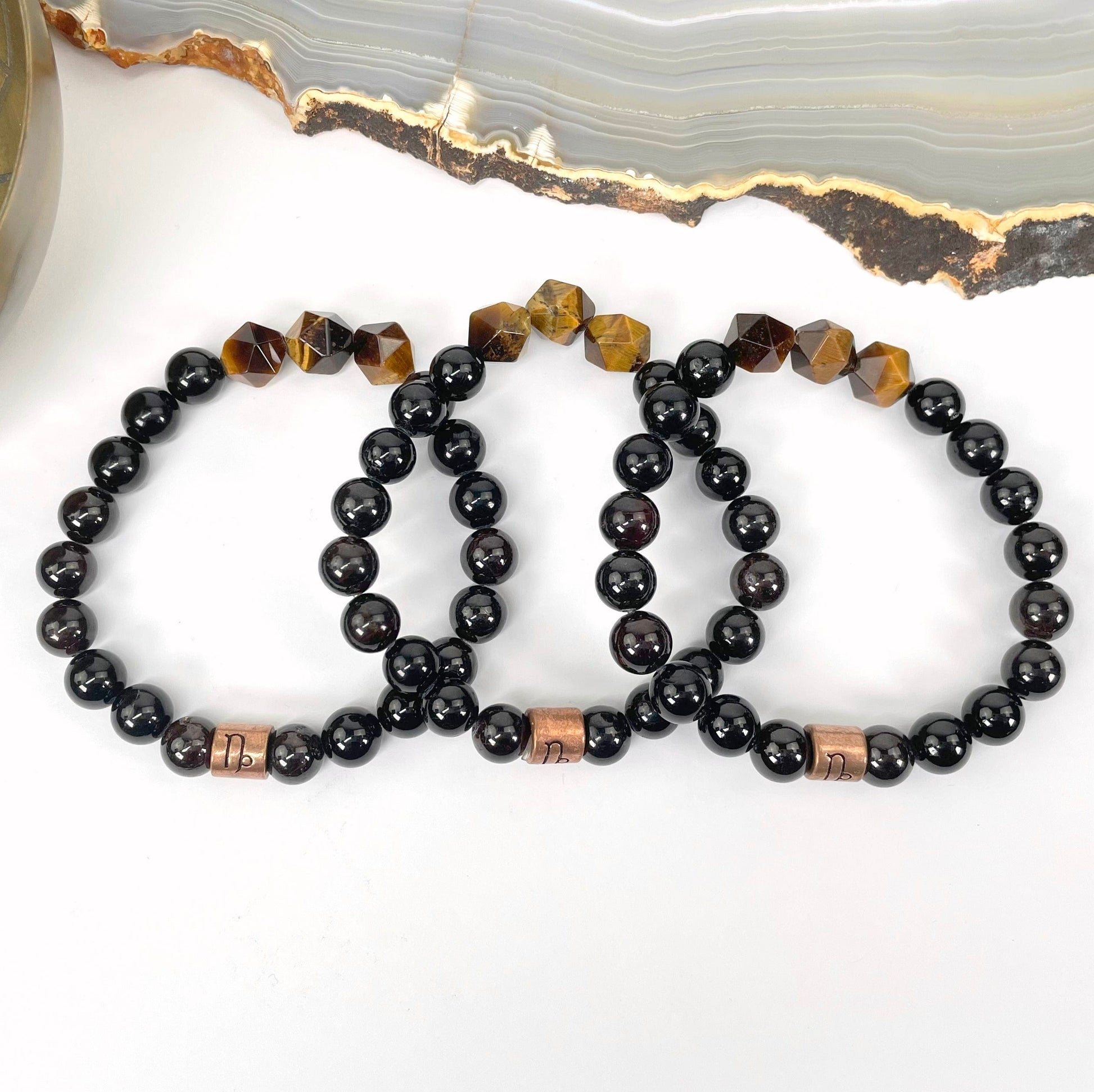 close up of capricorn zodiac bracelets for details and possible variations 