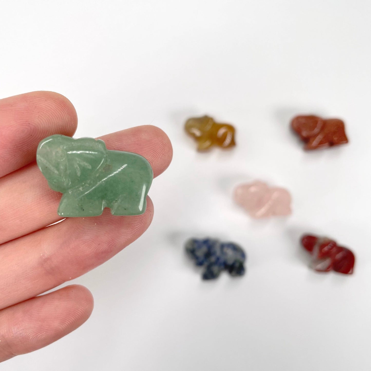 gemstone elephants in hand and on display