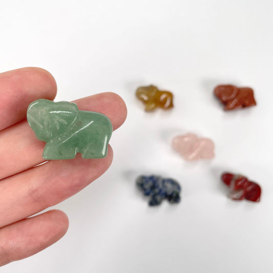 gemstone elephants in hand and on display