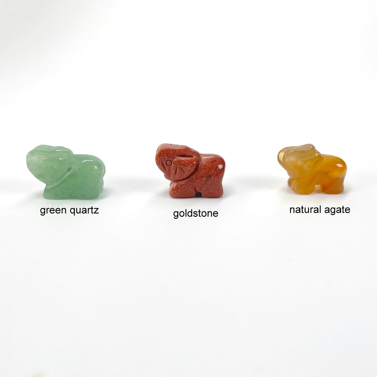 green quartz, goldstone, and natural agate gemstone elephants on display