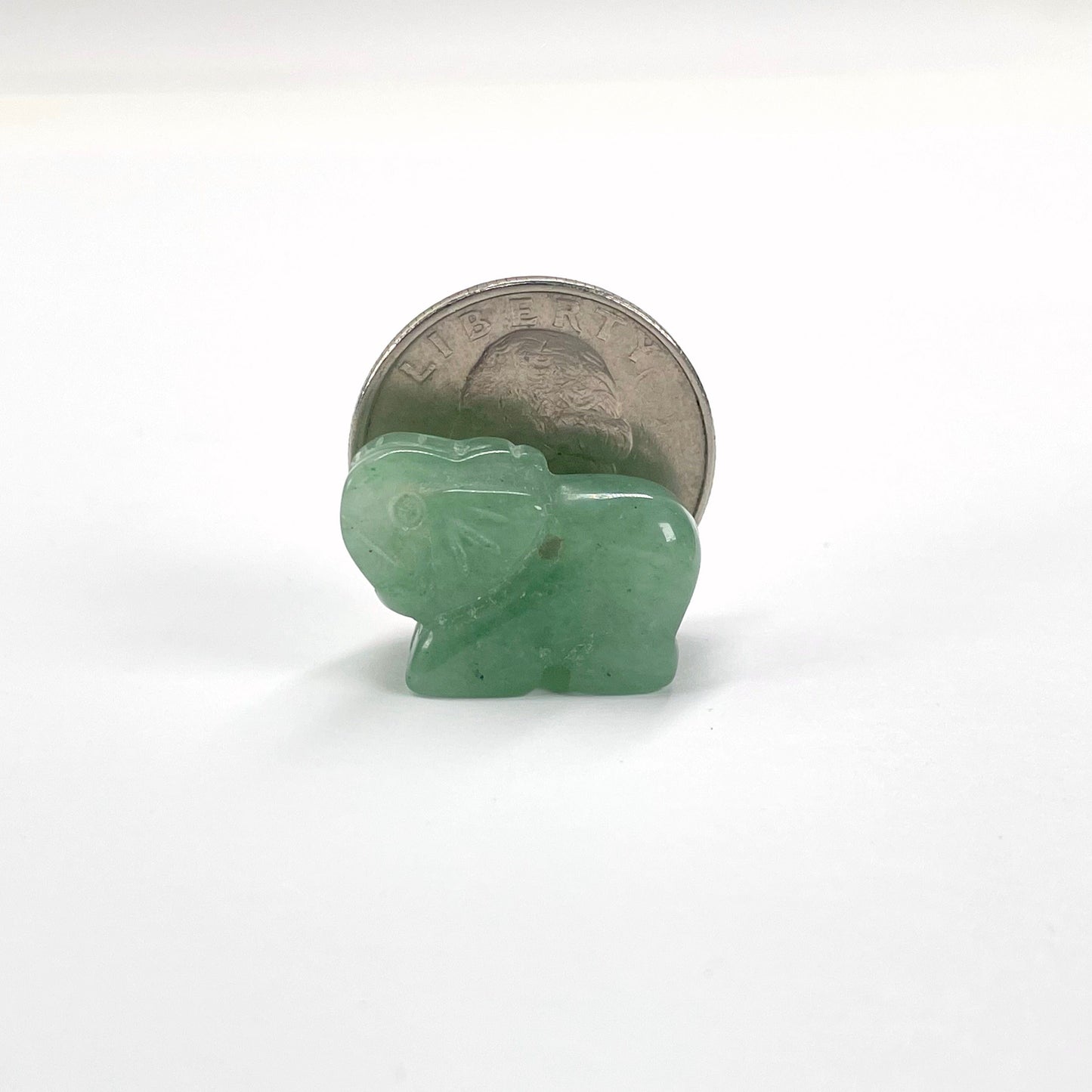 close up of gemstone elephant with quarter for size reference