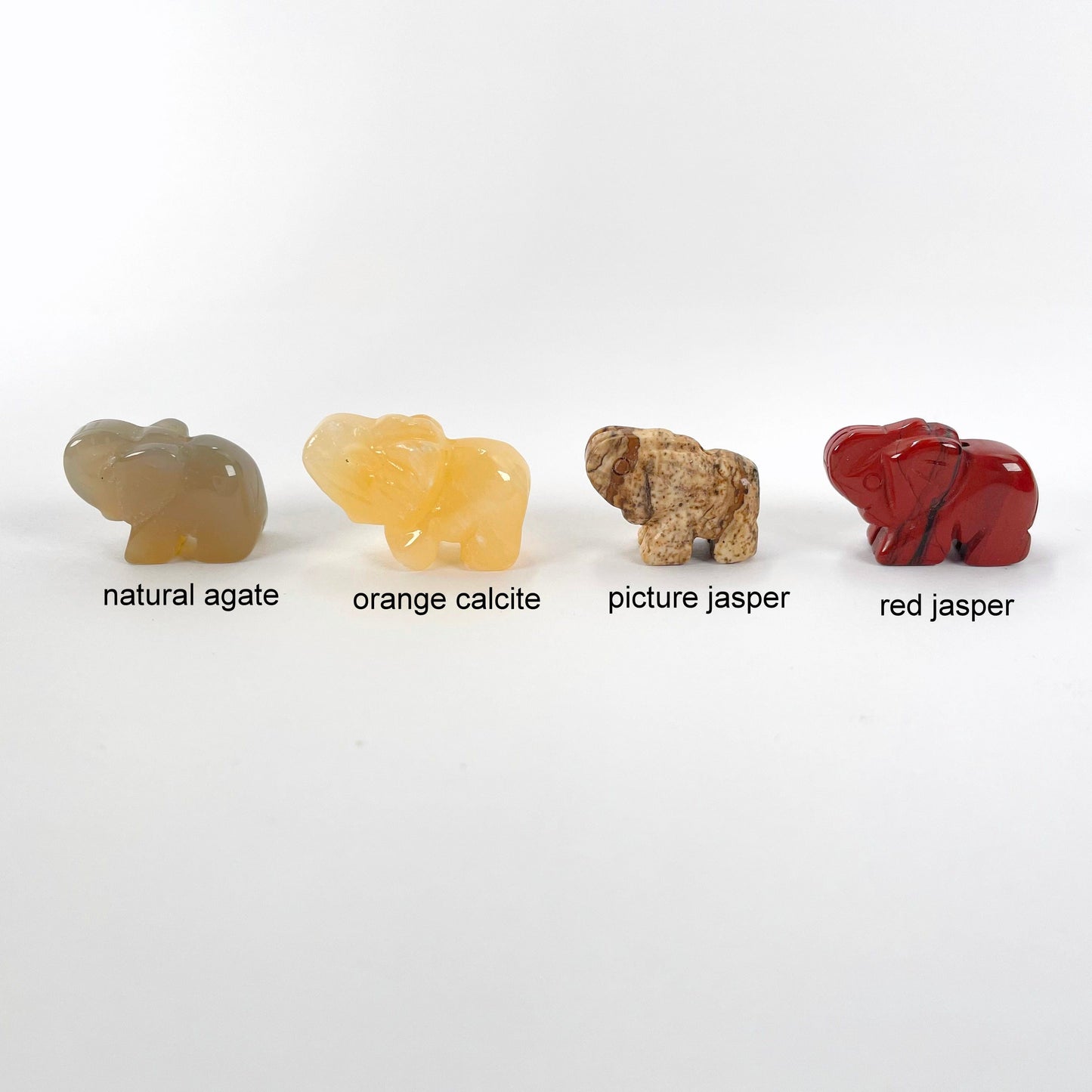 close up of natural agate, orange calcite, picture jasper, and red jasper gemstone elephant options