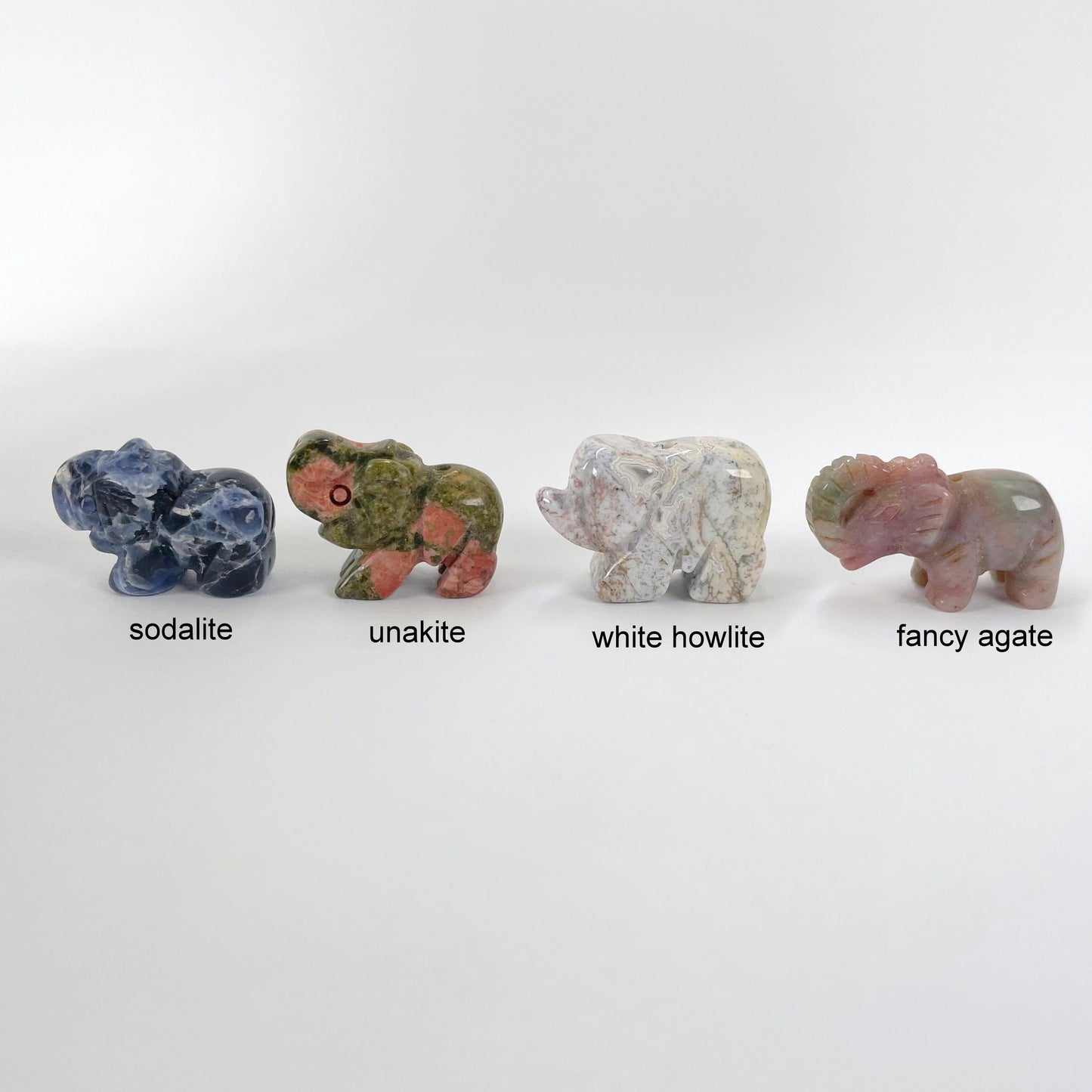 close up of sodalite, unakite, white howlite, and fancy agate gemstone elephant options