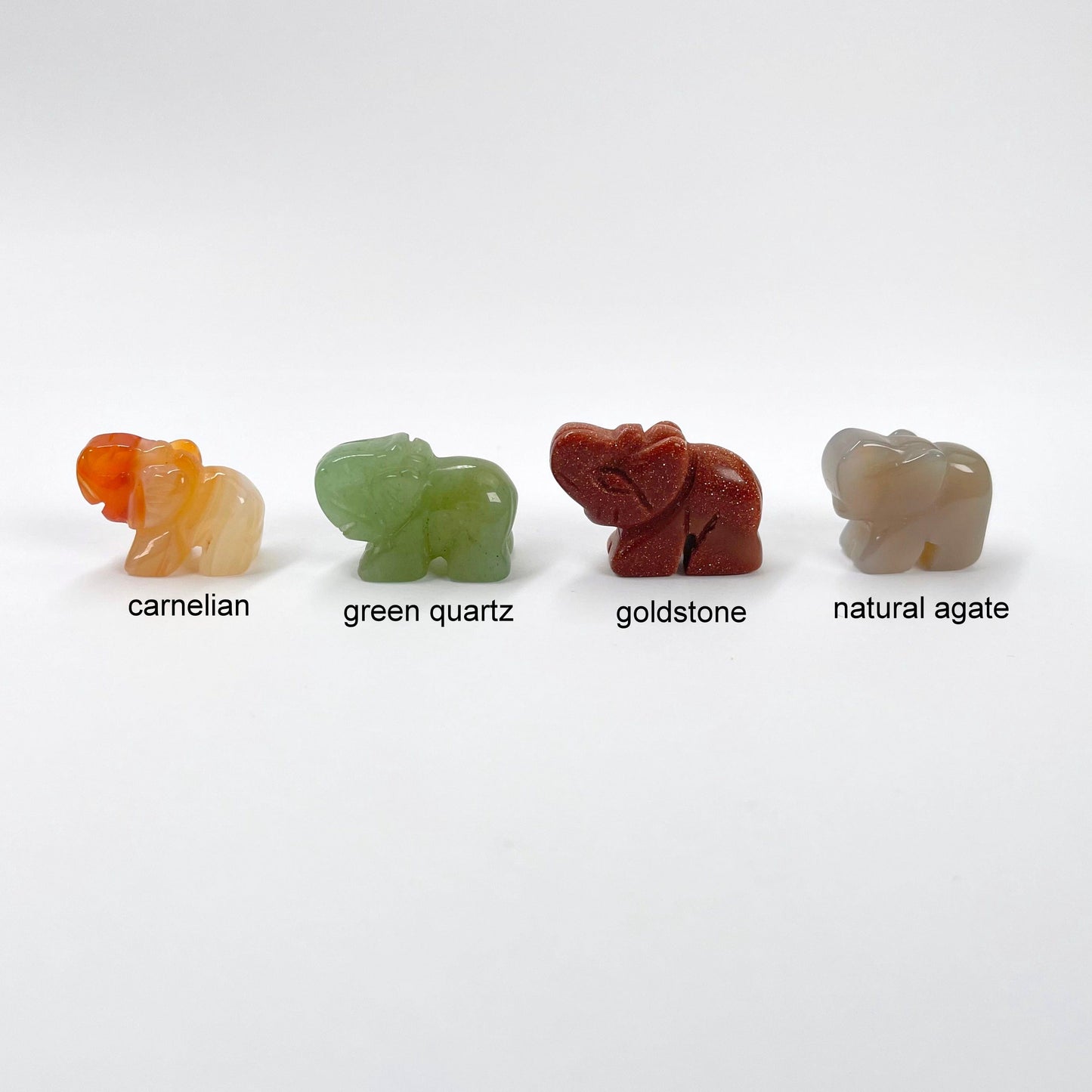 close up of carnelian, green quartz, goldstone, and natural agate gemstone elephants 