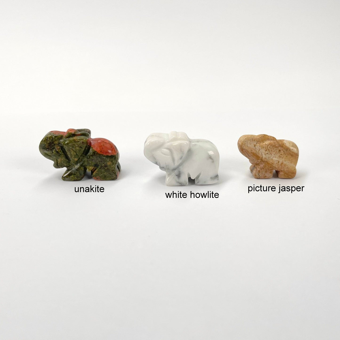 close up of unakite, white howlite, and picture jasper gemstone elephants