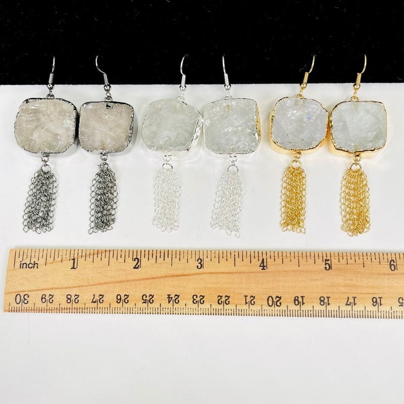earrings next to a ruler for size reference 