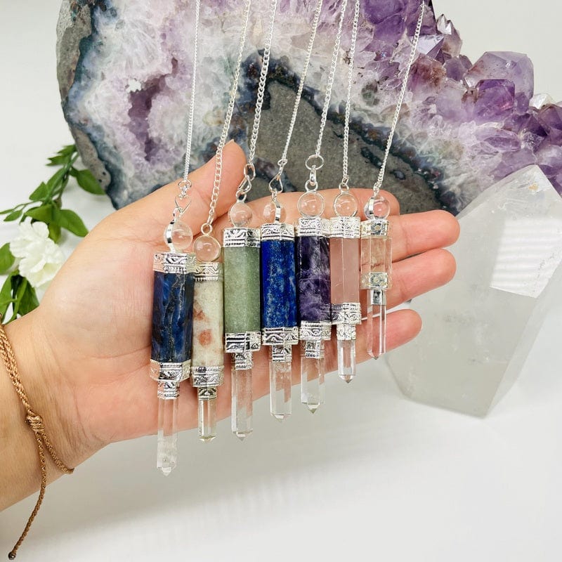 crystal pendulums in hand for size reference 