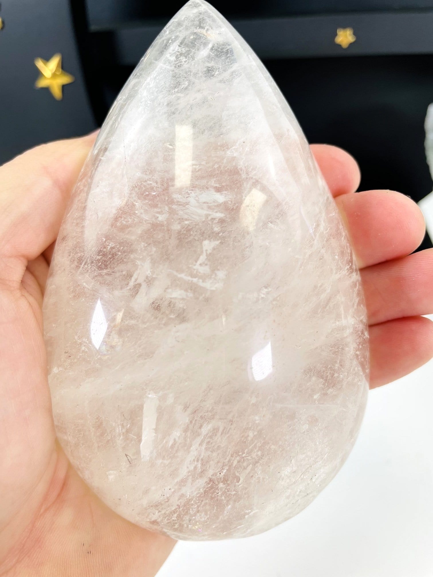 hand  holding up Clear Quartz Tear Drop Shape
