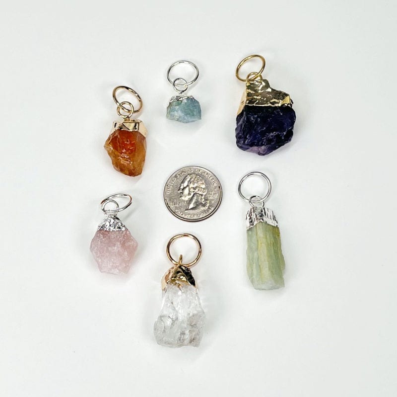 pendants next to a quarter for size reference 