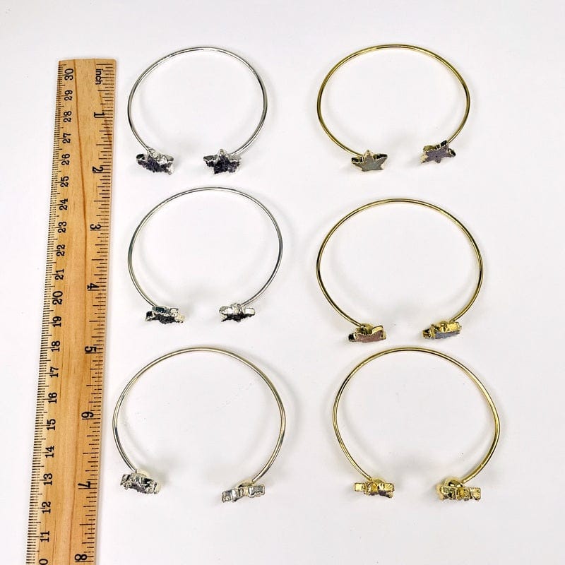 bracelets next to a ruler for size reference 