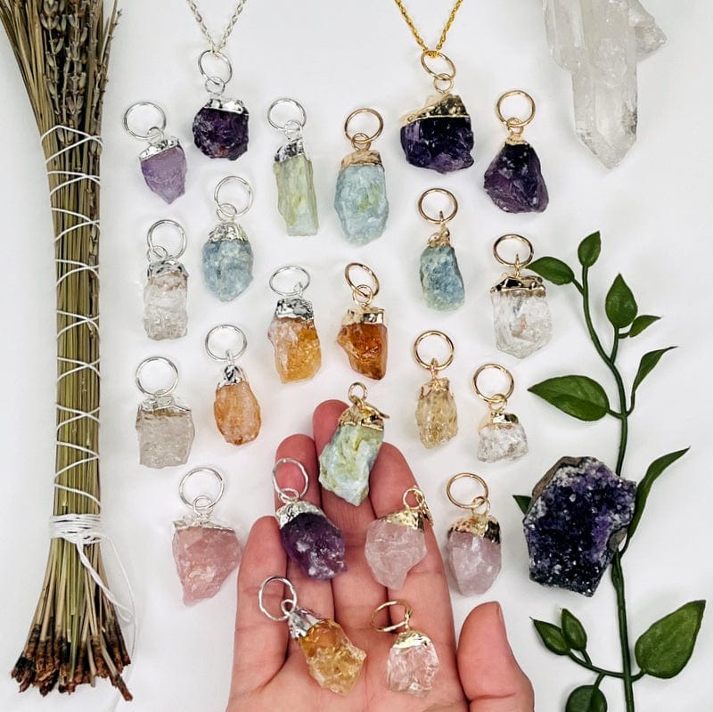 rough stone pendants with gold or silver cap and large hoop bails in hand for size reference 