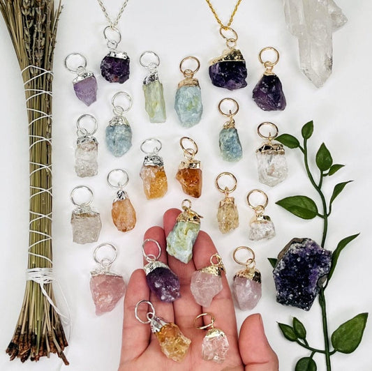 rough stone pendants with gold or silver cap and large hoop bails in hand for size reference 