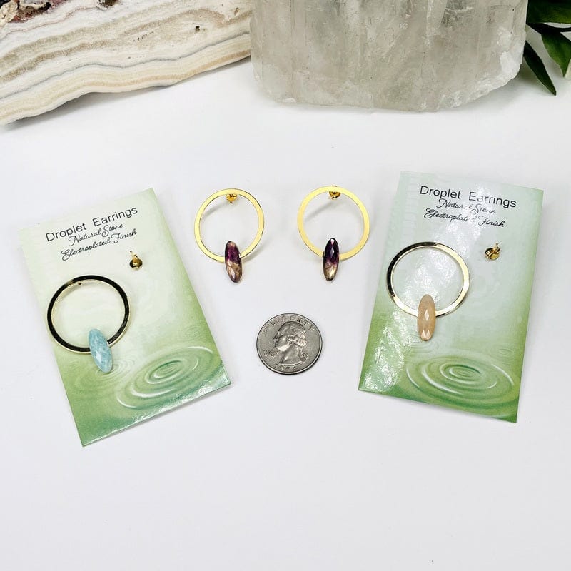 earrings next to a quarter for size reference 