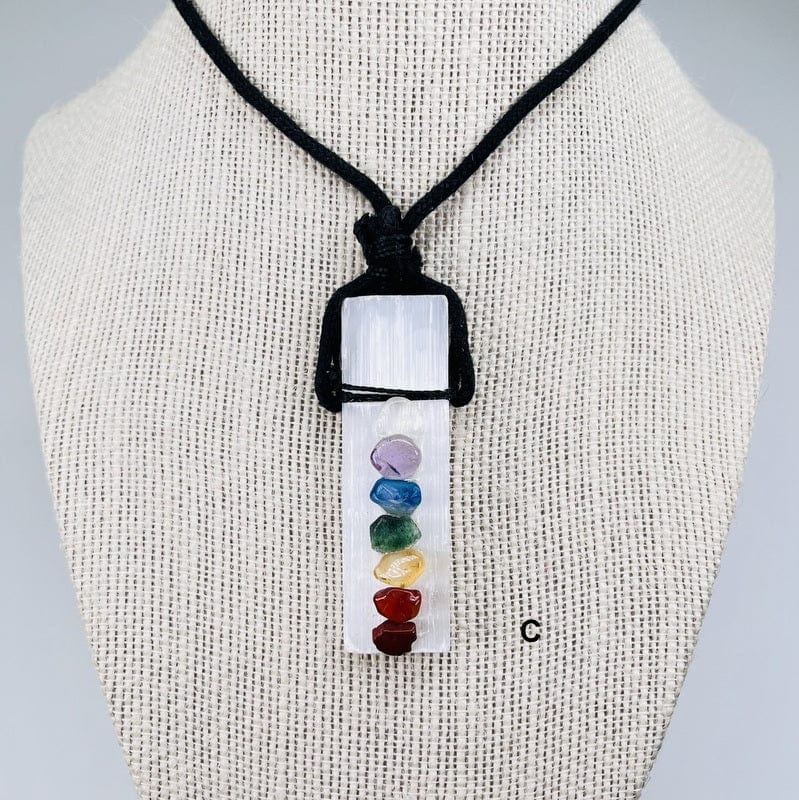close up of the selenite rod with the chakras on a black cord necklace 